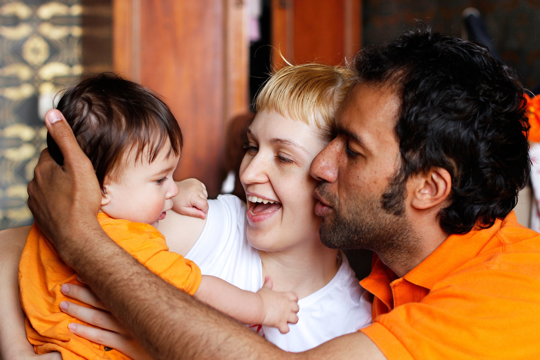 Parents holding their child.