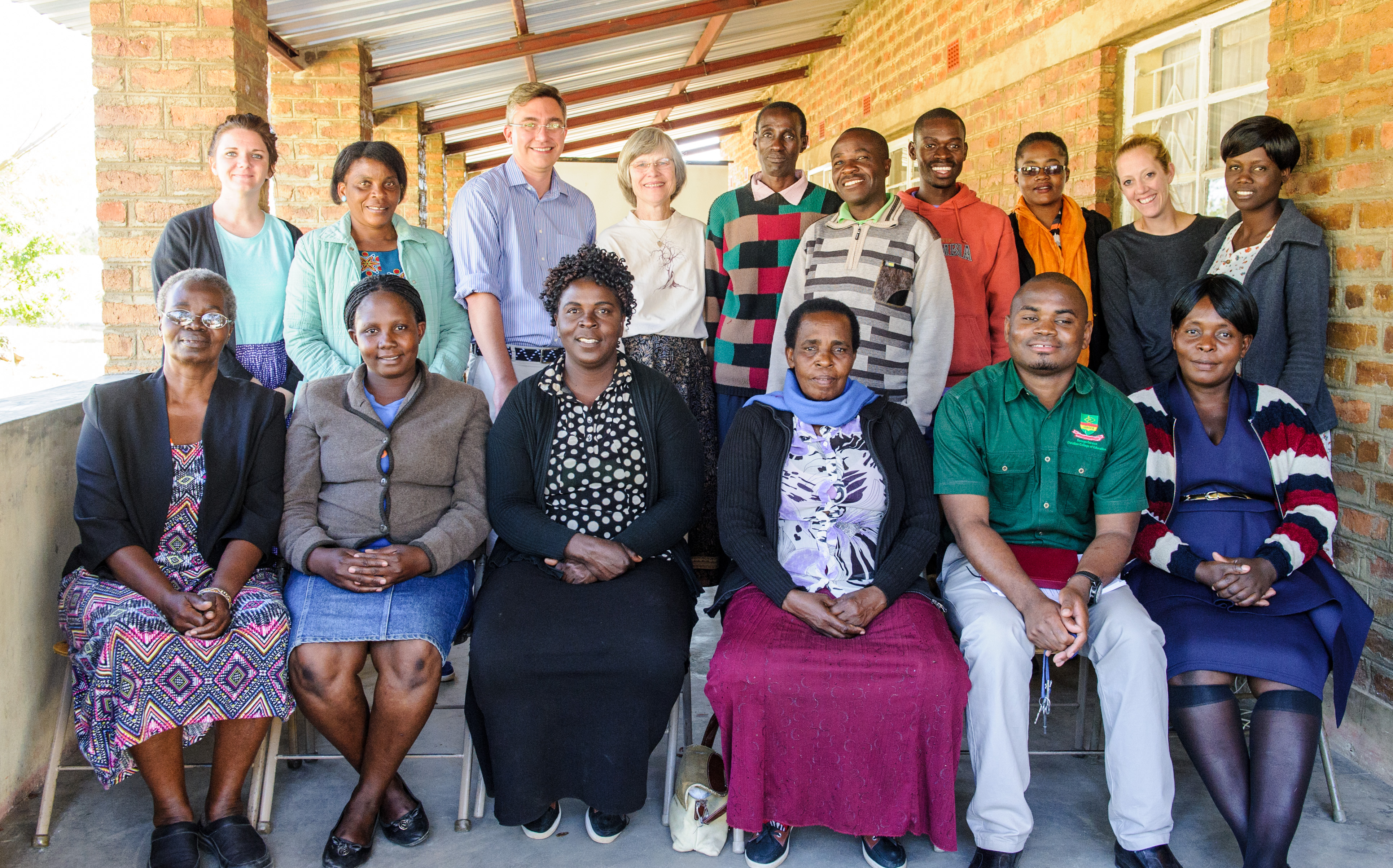 Dr. Reichow and Dr. Marylou Behnke pose with Zambian community members