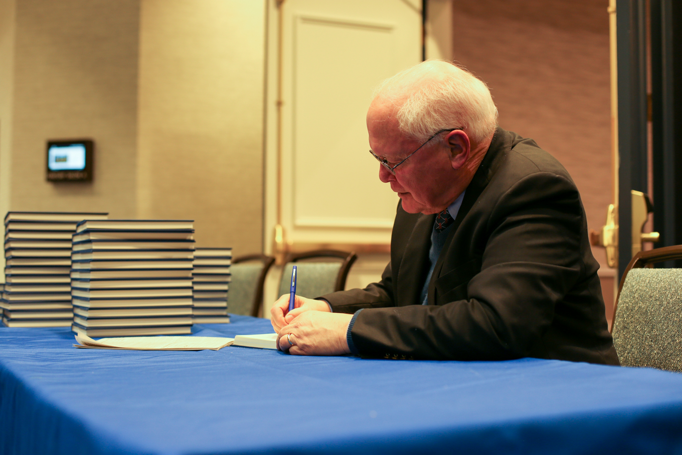 David Lawrence Jr. signing books at a table.
