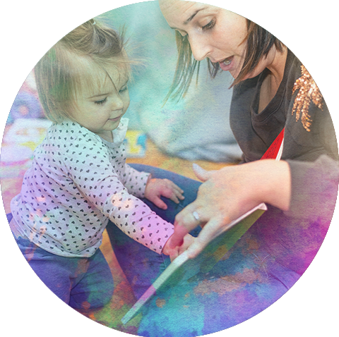 A woman reading a book to a child.