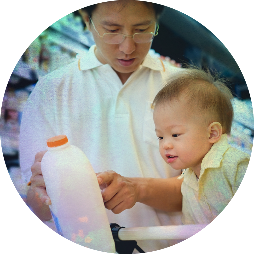 A father picking out milk with his son.